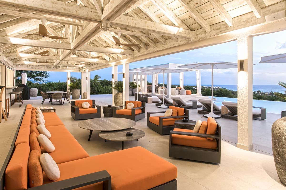 Covered outdoor lounge with plush seating and ocean views at Villa Avanti, St. Martin