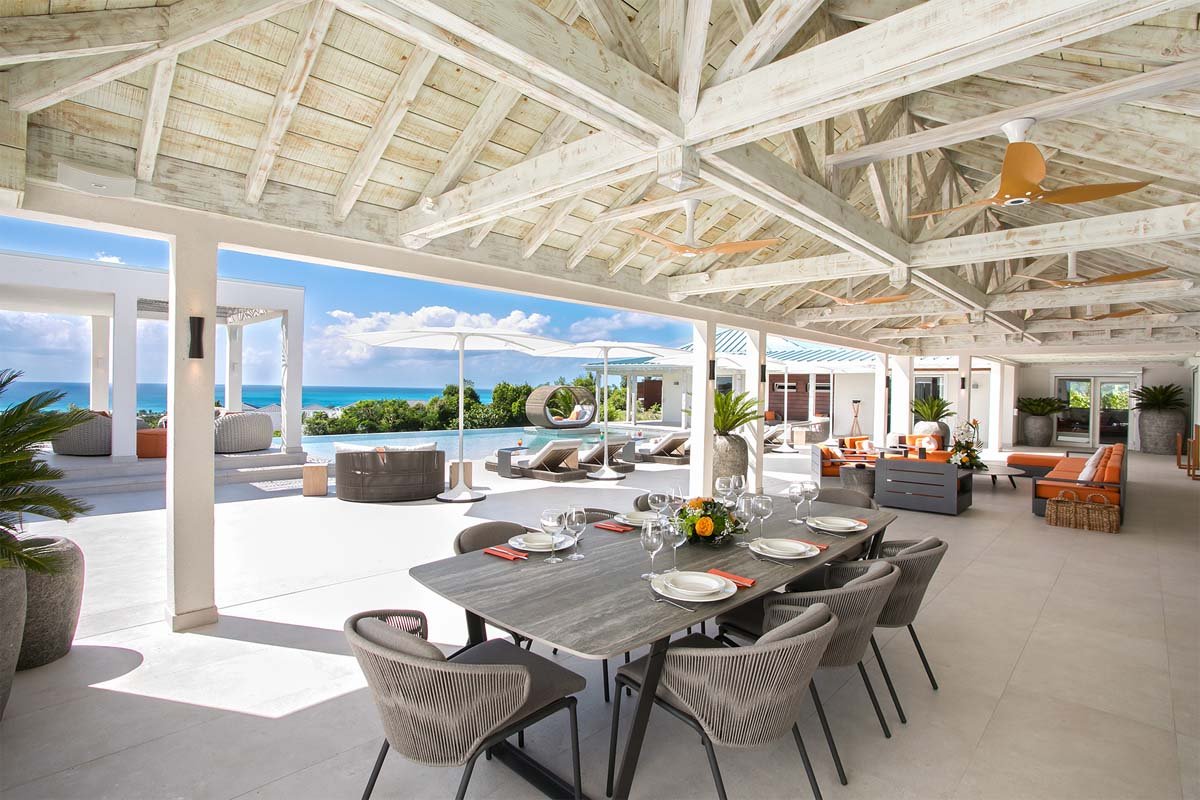 Covered outdoor lounge with plush seating and ocean views at Villa Avanti, St. Martin