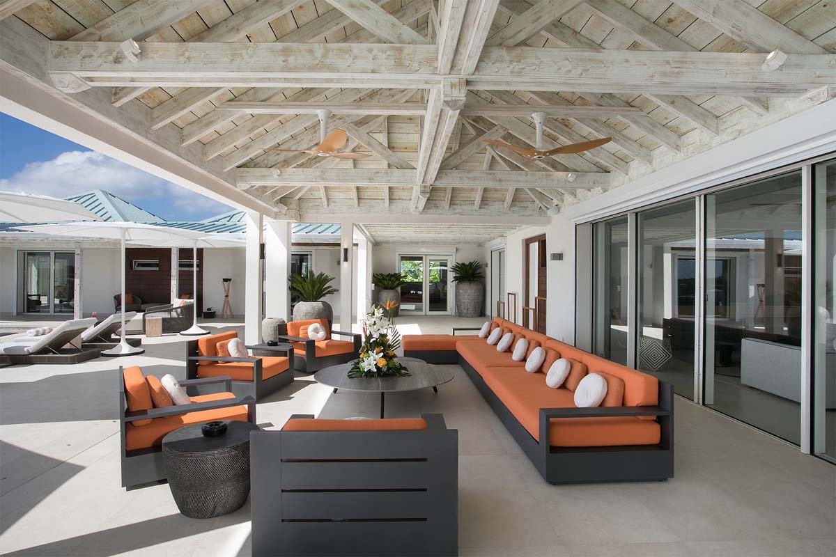 Covered outdoor lounge with ocean views and plush seating at Villa Avanti, St. Martin