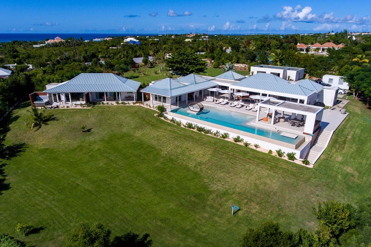 Aerial view of Villa Avanti showcasing its L-shaped pool and ocean views in Terres Basses, St. Martin