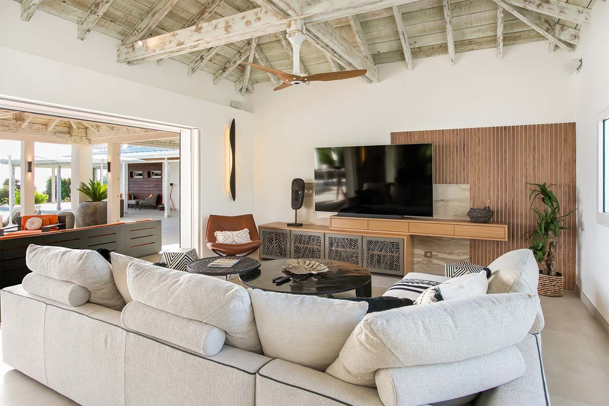 Spacious living room with ocean views, African-inspired decor, and 82” Smart TV at Villa Avanti, St. Martin.