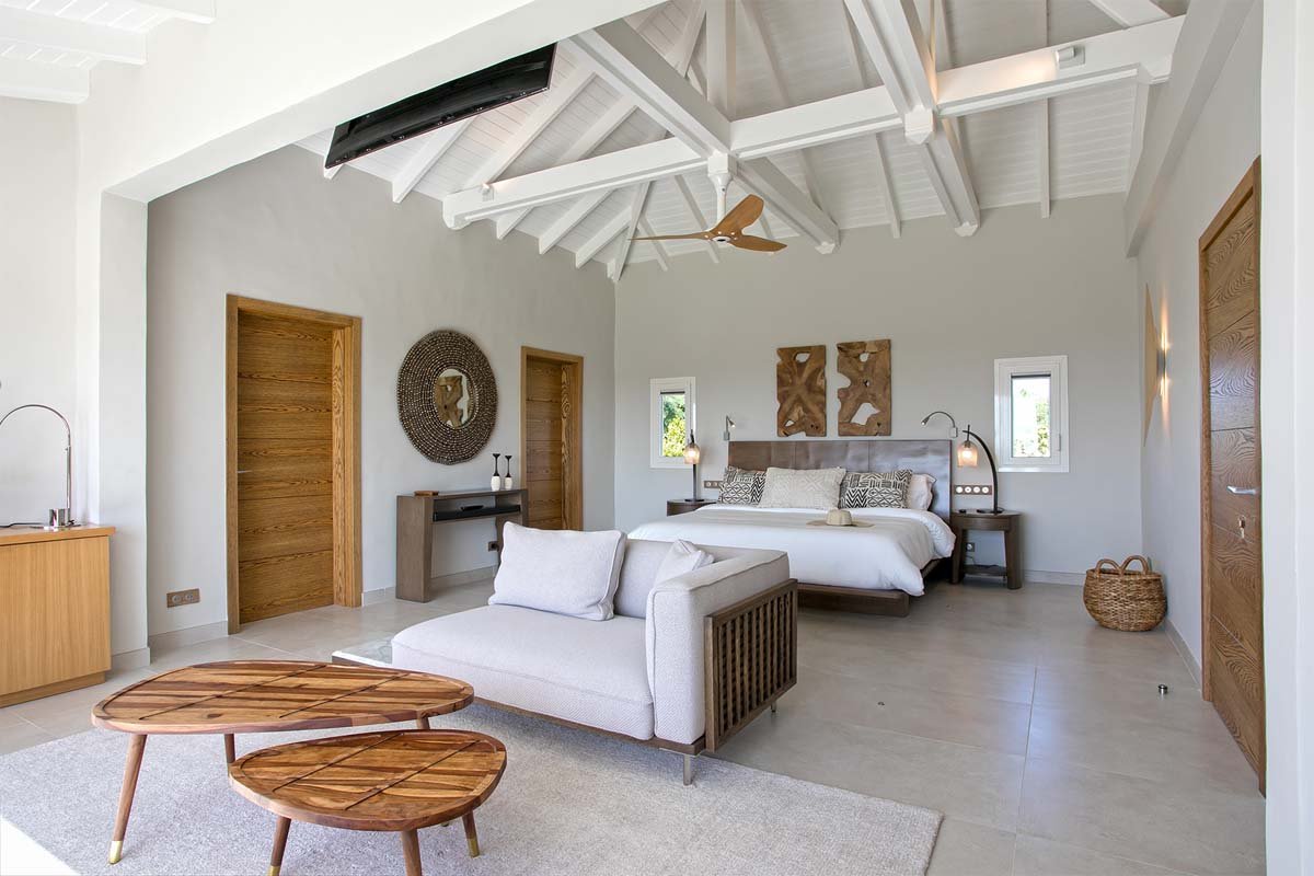 Master bedroom with king bed, private terrace, and ocean view at Villa Avanti, St. Martin