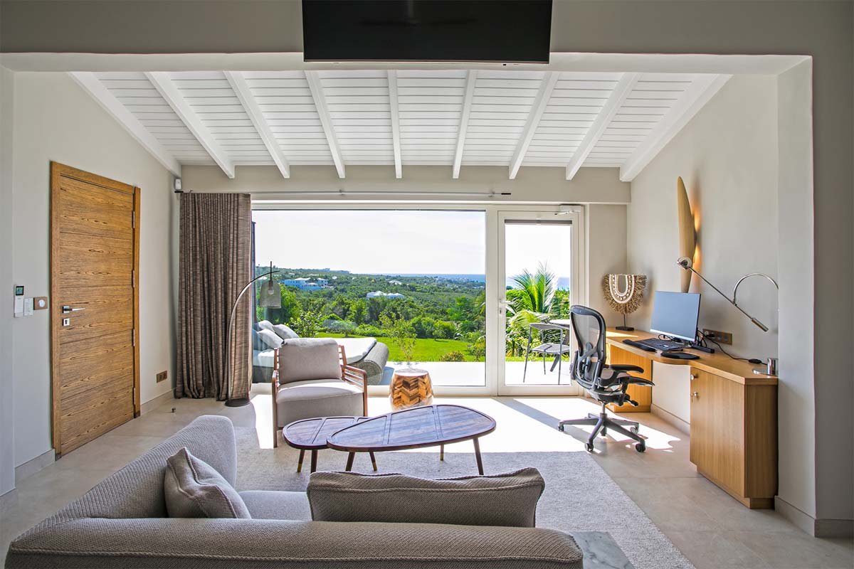 Master bedroom with king bed, private terrace, and ocean view at Villa Avanti, St. Martin.