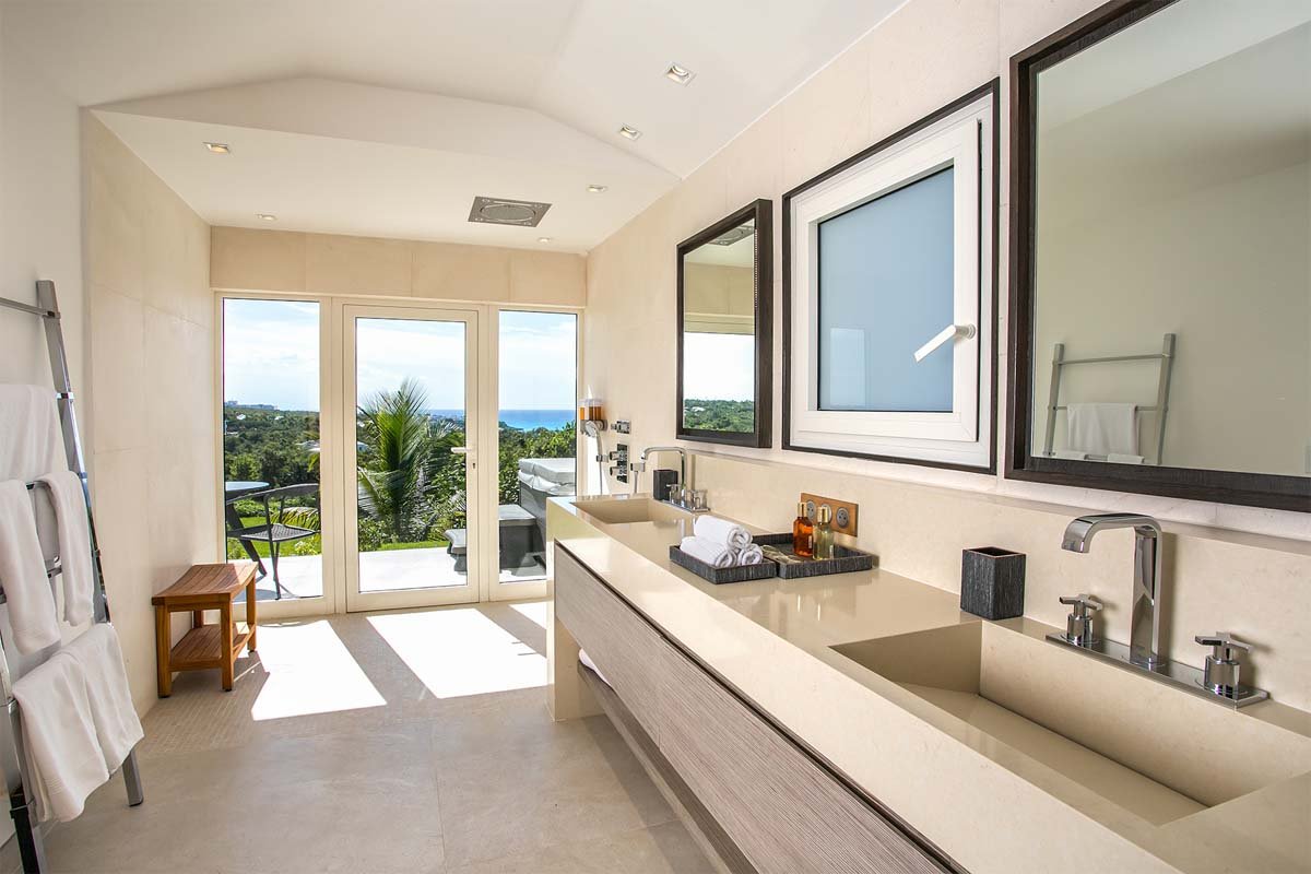 Master bathroom with Jacuzzi, rain shower, double vanity, and garden shower at Villa Avanti, St. Martin