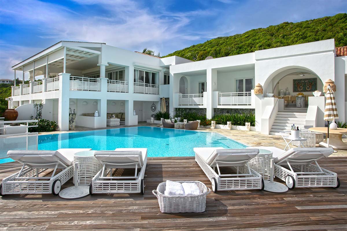 Infinity-edge pool with submerged loungers and gazebo at Villa L'Oasis, Terres Basses, St. Martin.