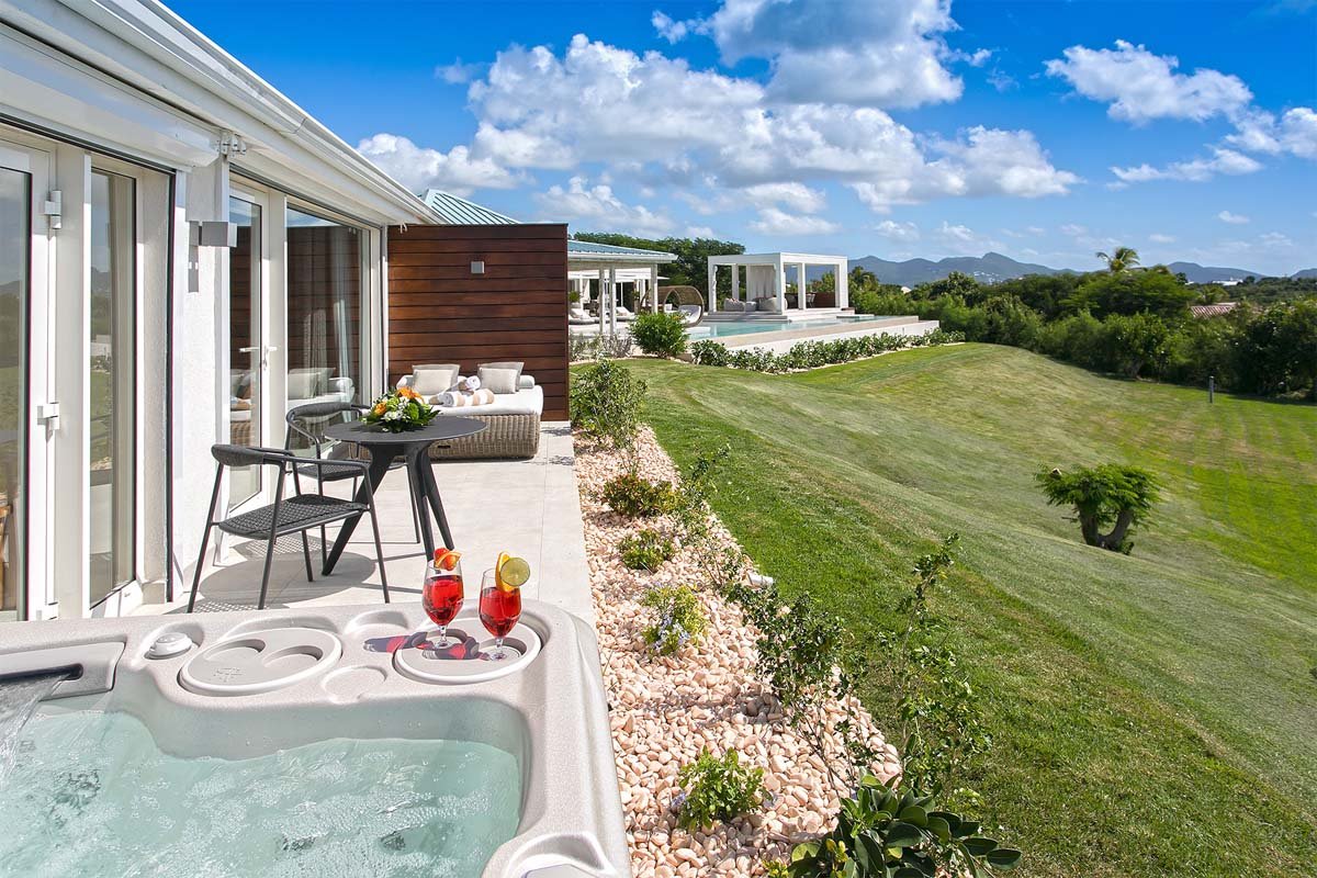 Master bathroom with Jacuzzi, rain shower, double vanity, and garden shower at Villa Avanti, St. Martin