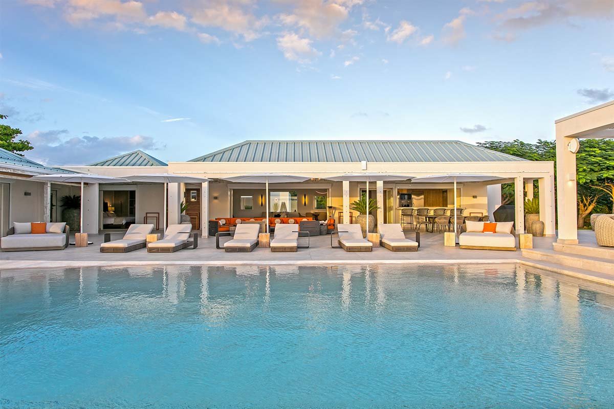 L-shaped saltwater pool with built-in seating, daybed, and gazebo at Villa Avanti, St. Martin