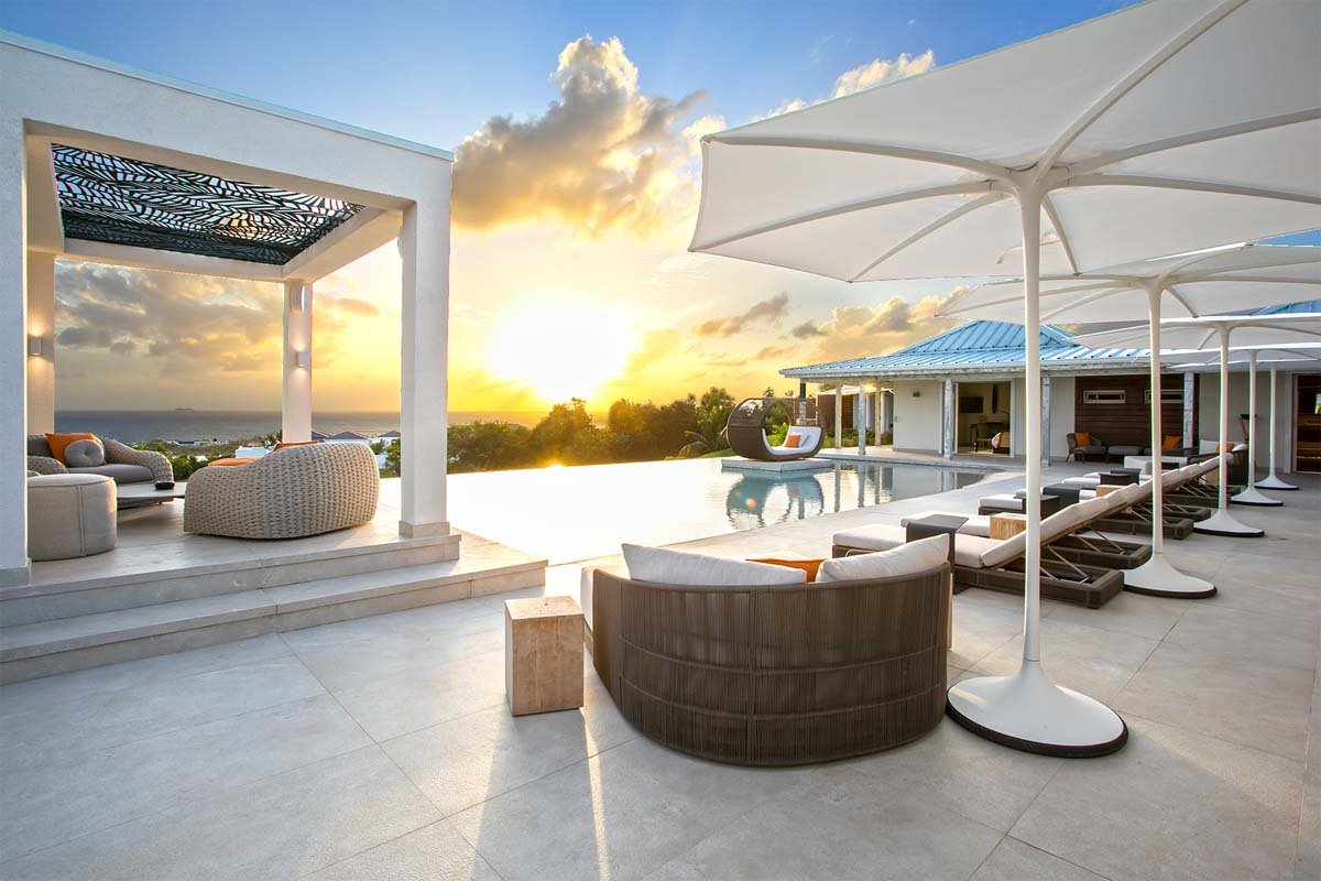 L-shaped saltwater pool with built-in seating, daybed, and gazebo at Villa Avanti, St. Martin
