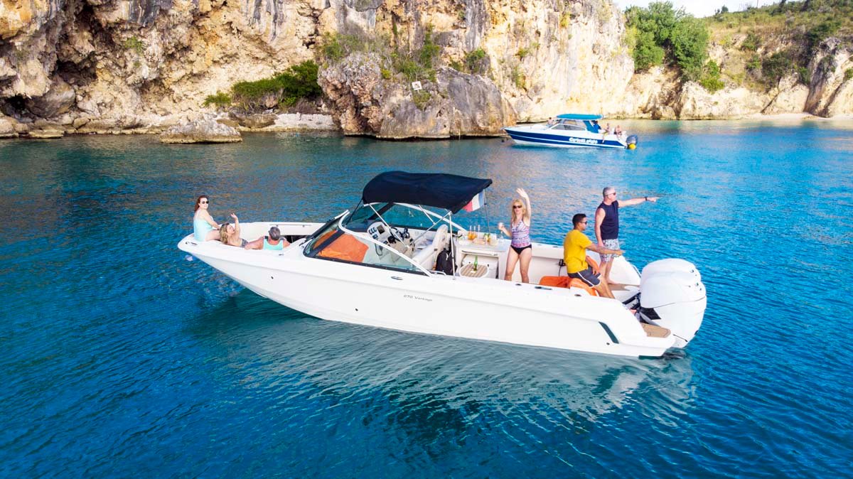 Side profile of a Boston Whaler center console boat, showcasing its open deck and durable design.