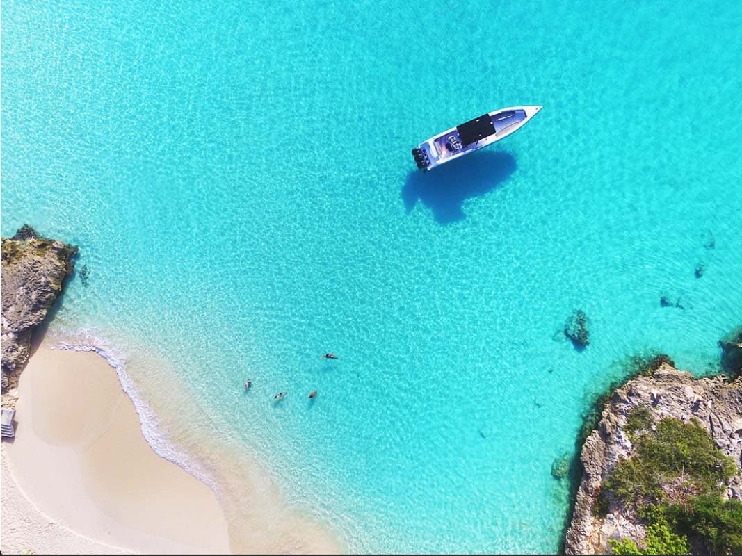 Donzi ZF Impulse 38FT powerboat anchored at a pristine beach in St. Martin.