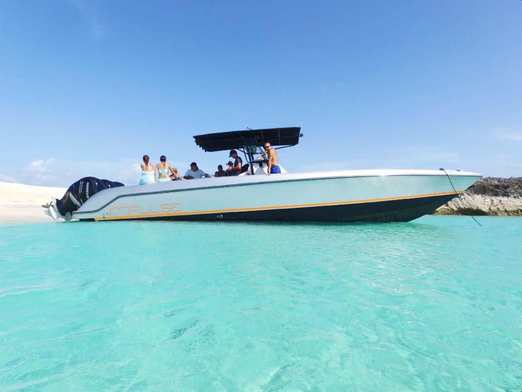 Donzi ZF Impulse 38FT powerboat cruising near St. Martin coastline, ideal for private charters