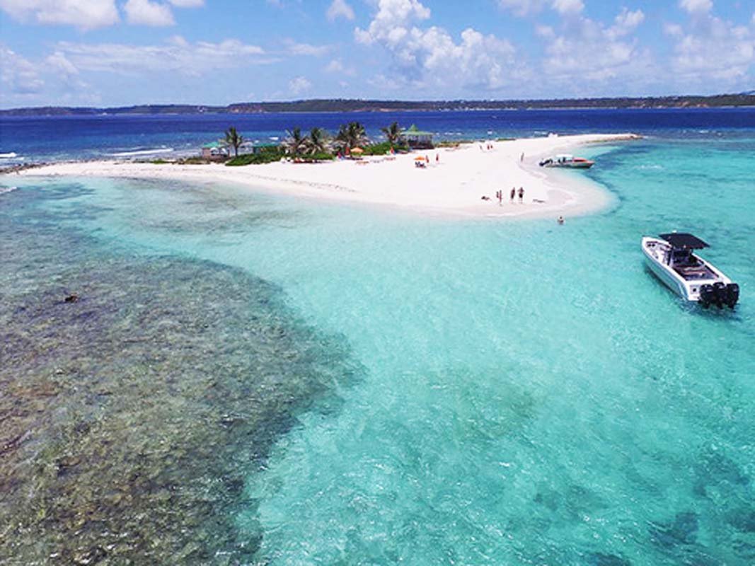 Private speedboat cruising turquoise waters near St. Martin, offering luxury charter experiences