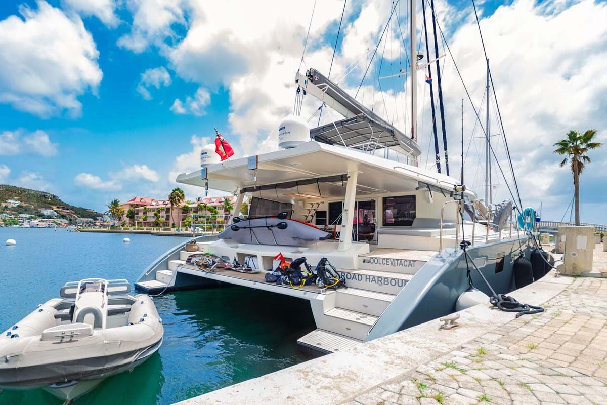 Sunreef 62 catamaran cruising turquoise sea, luxury yacht in St. Maarten