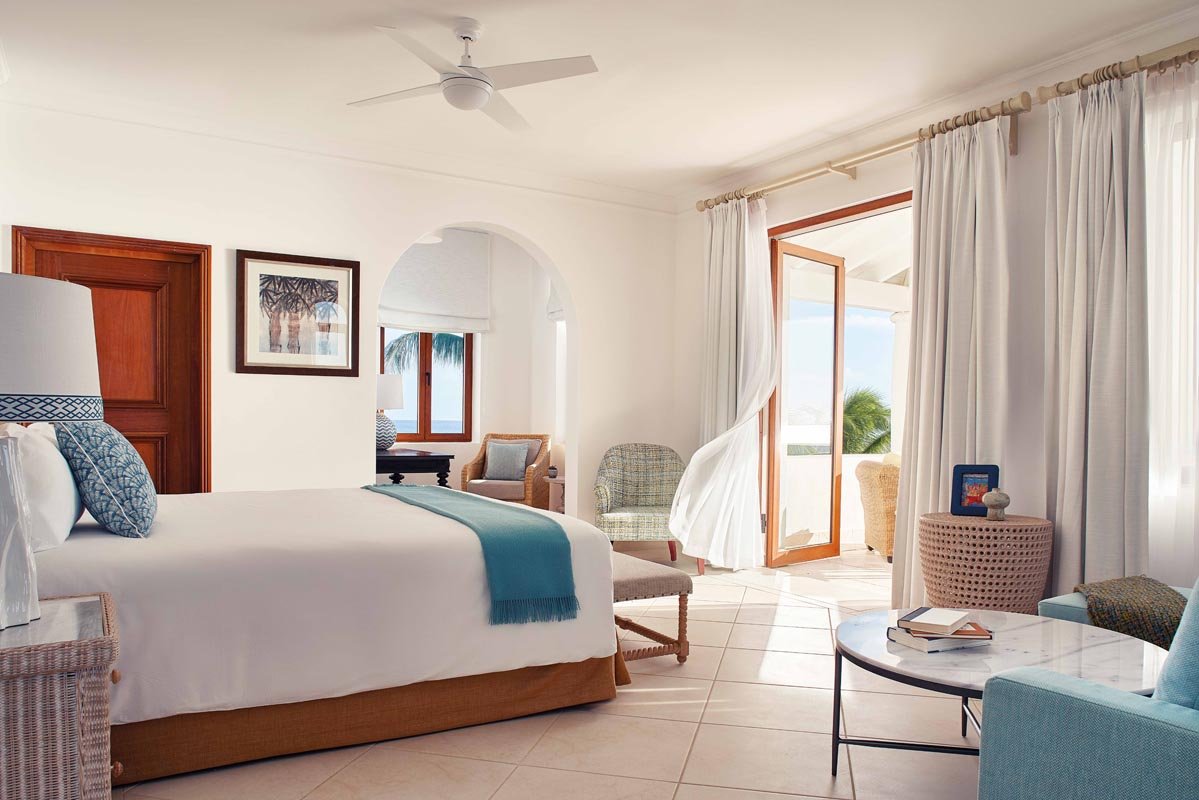 Signature Villa at Belmond La Samanna, featuring a spacious living area, private infinity pool, and panoramic views of Baie Longue Beach.