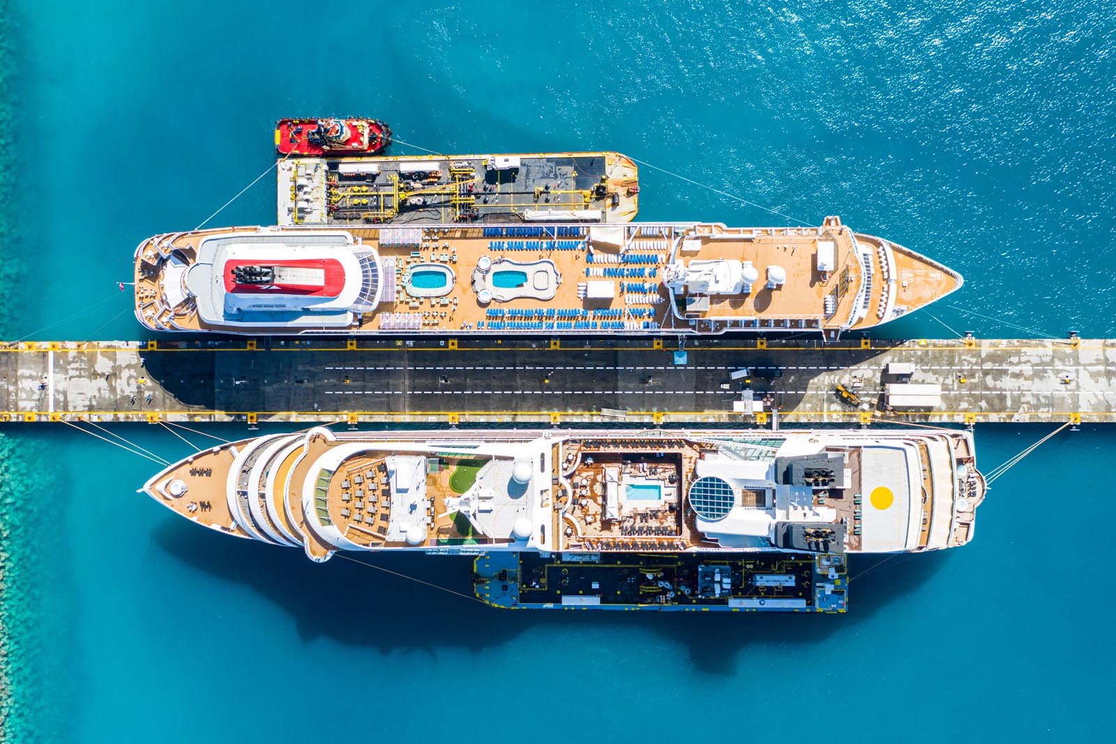 “Marvel at the Spectacle of Two Giant Cruise Ships in Port Sint Maarten – Philipsburg” Aerial view of two giant cruise ships docked in Port Sint Maarten - Philipsburg