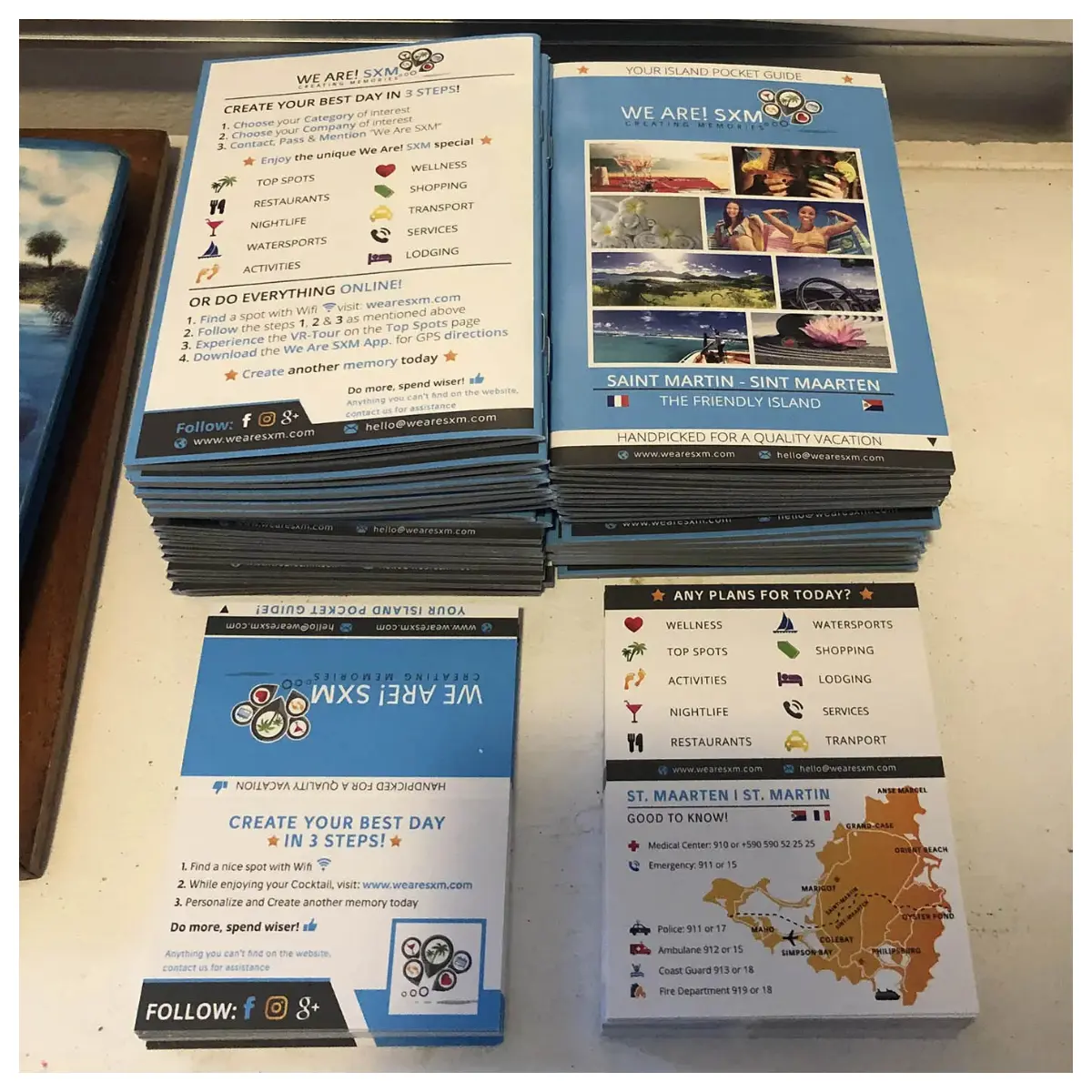 The first edition of the Island Pocket Guide by We Are! SXM, featuring a vibrant map of St. Maarten – St. Martin with color-coded categories for easy navigation.