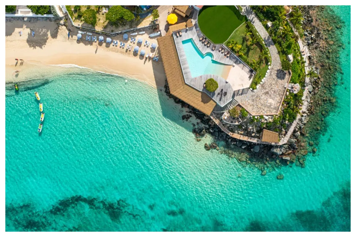 Aerial bird’s-eye view of Grand Case Beach Club, showing beach, rooftops, and turquoise sea in St. Martin