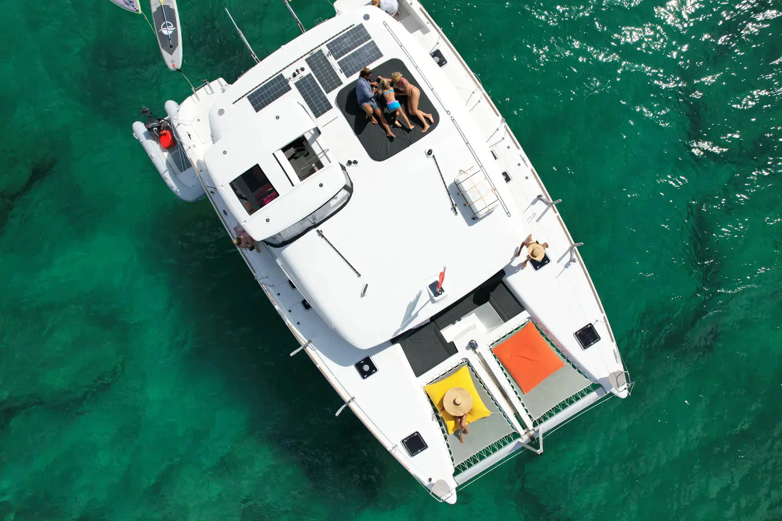 Aerial view of Lagoon 450S power catamaran 'Galaxy' anchored in turquoise waters off St. Maarten, showcasing its sleek design and spacious deck.