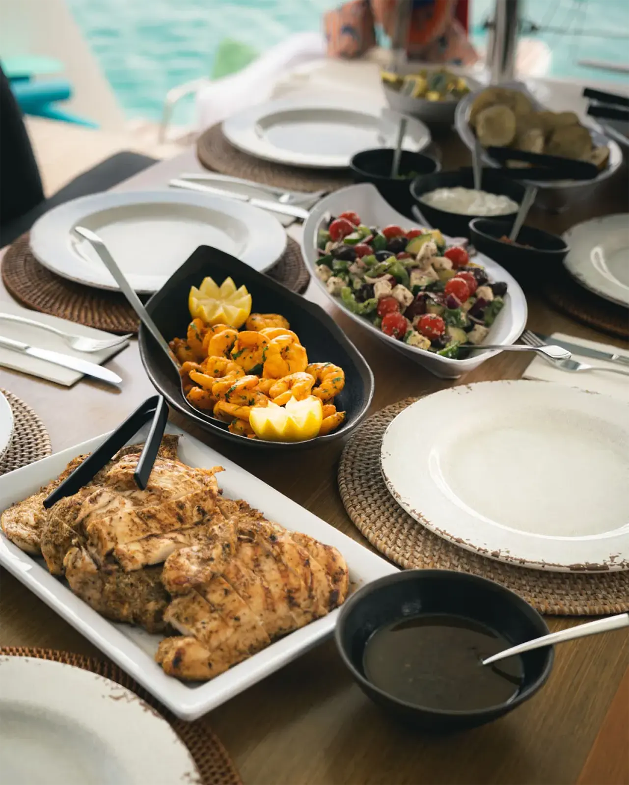 Grilled chicken, shrimp, salad buffet setup aboard Renegades catamaran in St. Maarten.