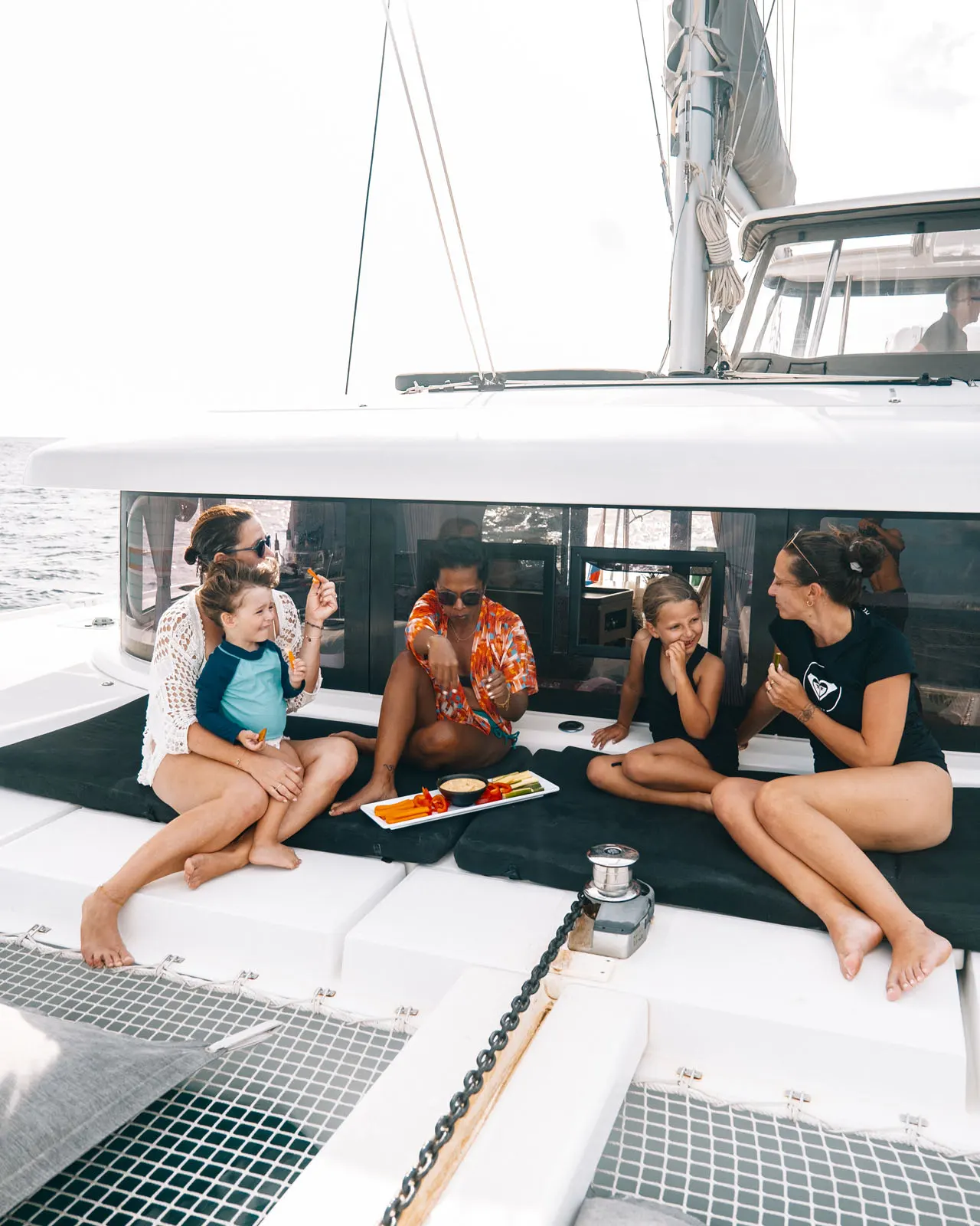 Guests lounging on Renegades catamaran deck in St. Maarten