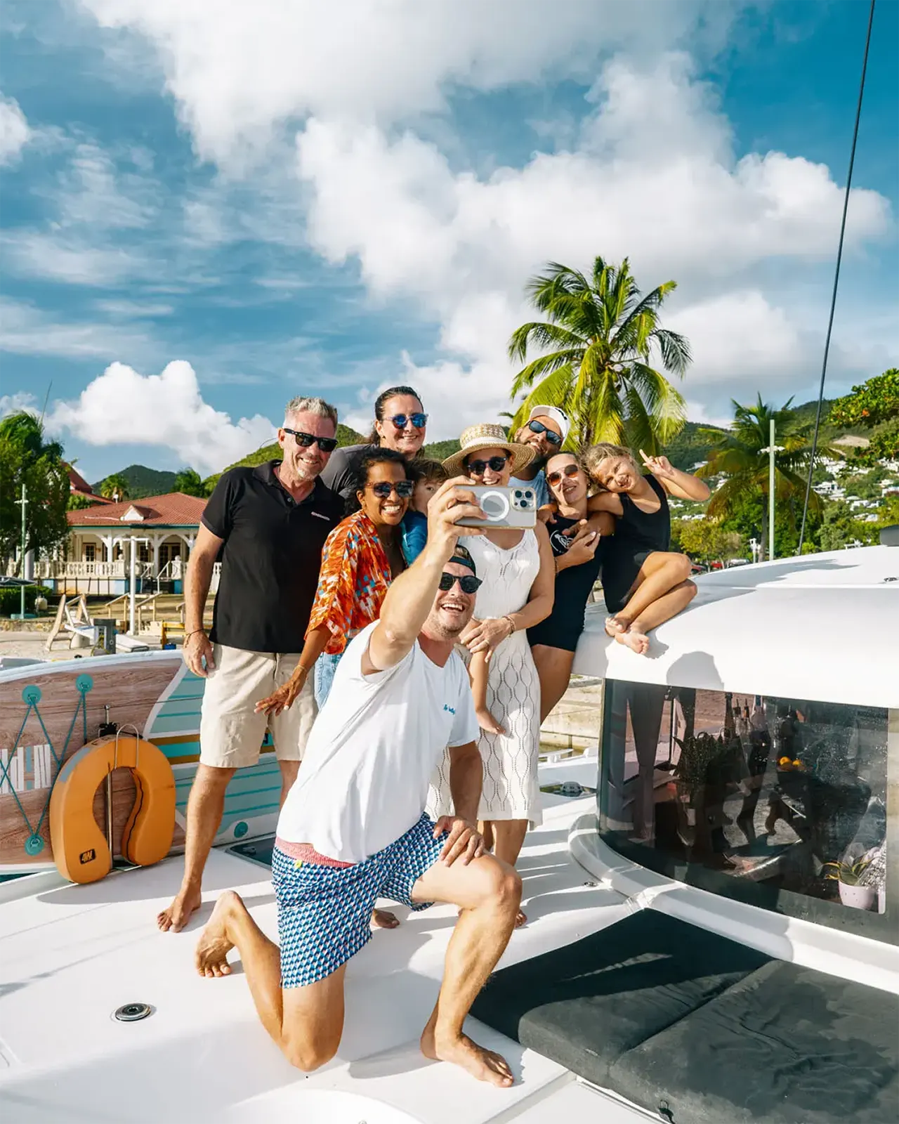 Guests relaxing on Renegades catamaran deck near St. Maarten shore
